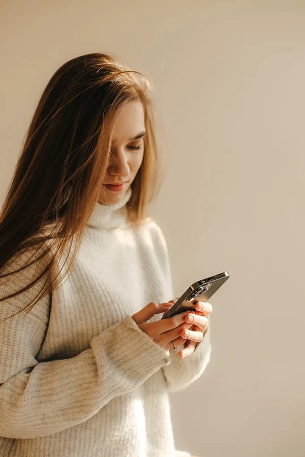 Person checking SMS notifications on a phone