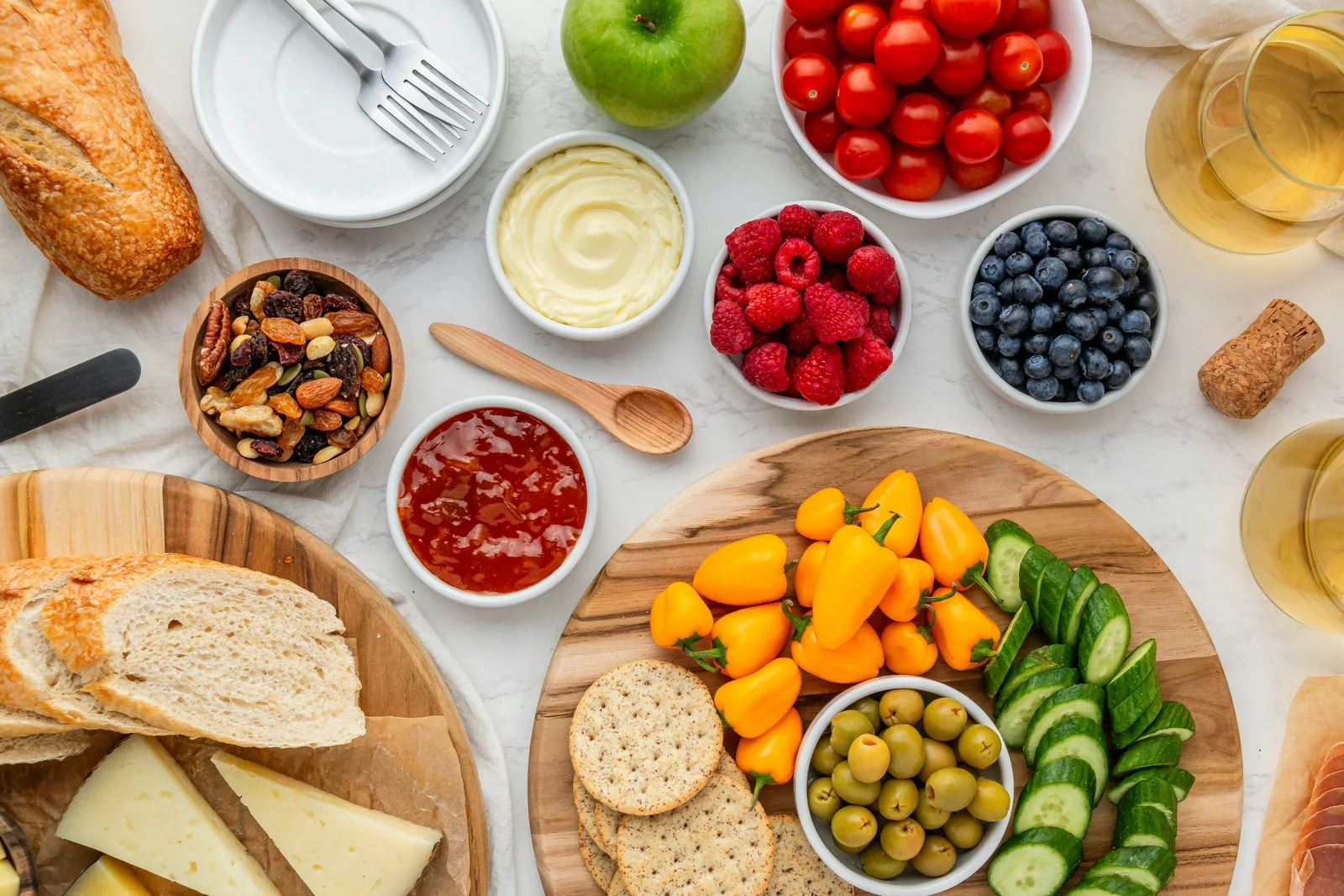 A selection of foods including fruit, vegetables, nuts, and bread